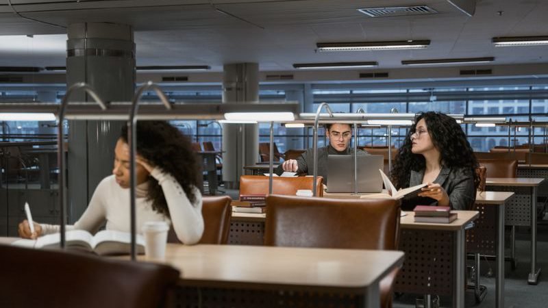 Postgraduate students working in a university library